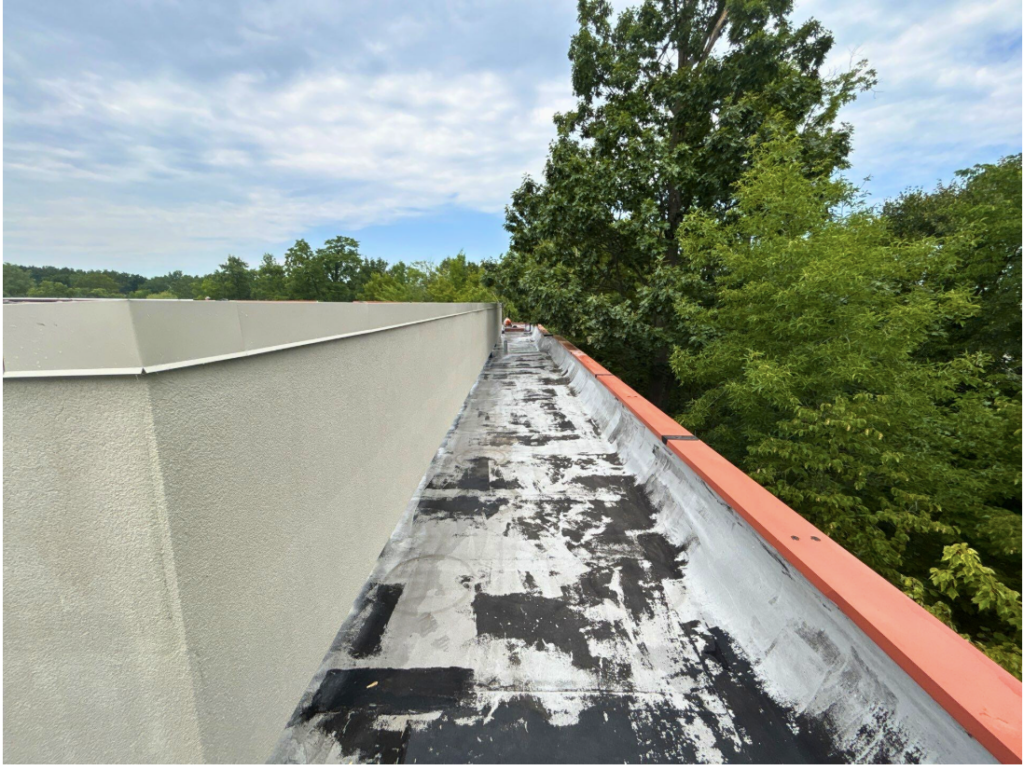 Technician inspecting rooftop HVAC penetrations as part of a commercial roof inspection checklist 