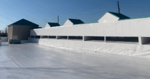 Commercial roof ventilation system with HVAC unit on reflective membrane providing efficient airflow