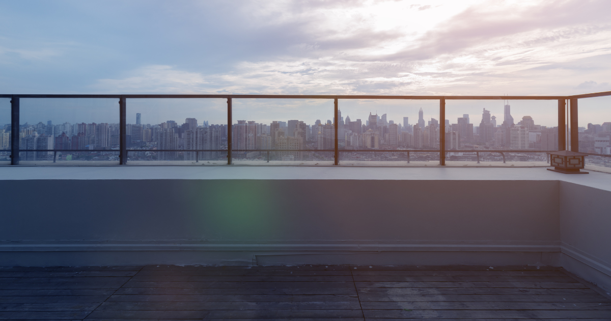 Commercial rooftop overlooking city skyline, illustrating roof color and energy impact in urban settings.