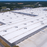 A large commercial building with UV resistant roof coatings designed to reflect sunlight and reduce heat absorption.