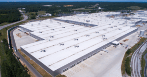 A large commercial building with UV resistant roof coatings designed to reflect sunlight and reduce heat absorption.