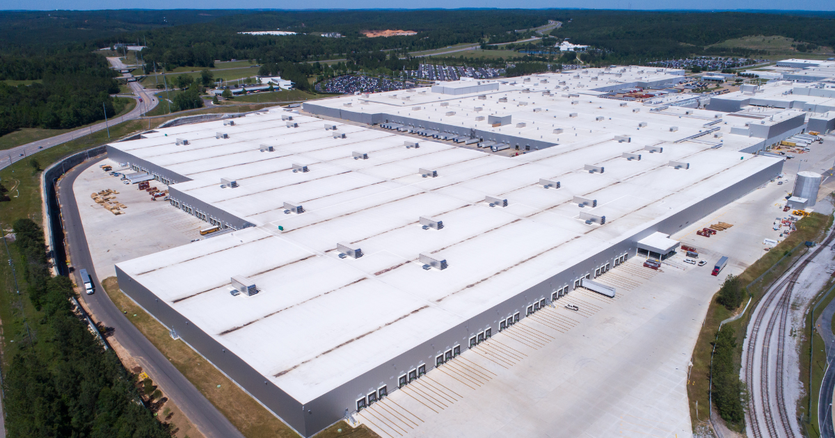 A large commercial building with UV resistant roof coatings designed to reflect sunlight and reduce heat absorption.