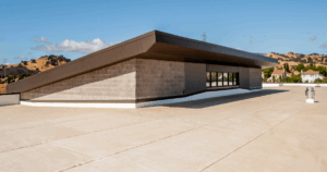 Flat commercial roof under clear skies, ideal for assessing roof replacement vs repair needs.