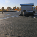 Commercial flat roof with proper drainage system handling rainwater