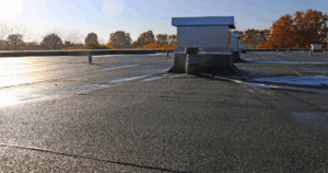 Commercial flat roof with proper drainage system handling rainwater