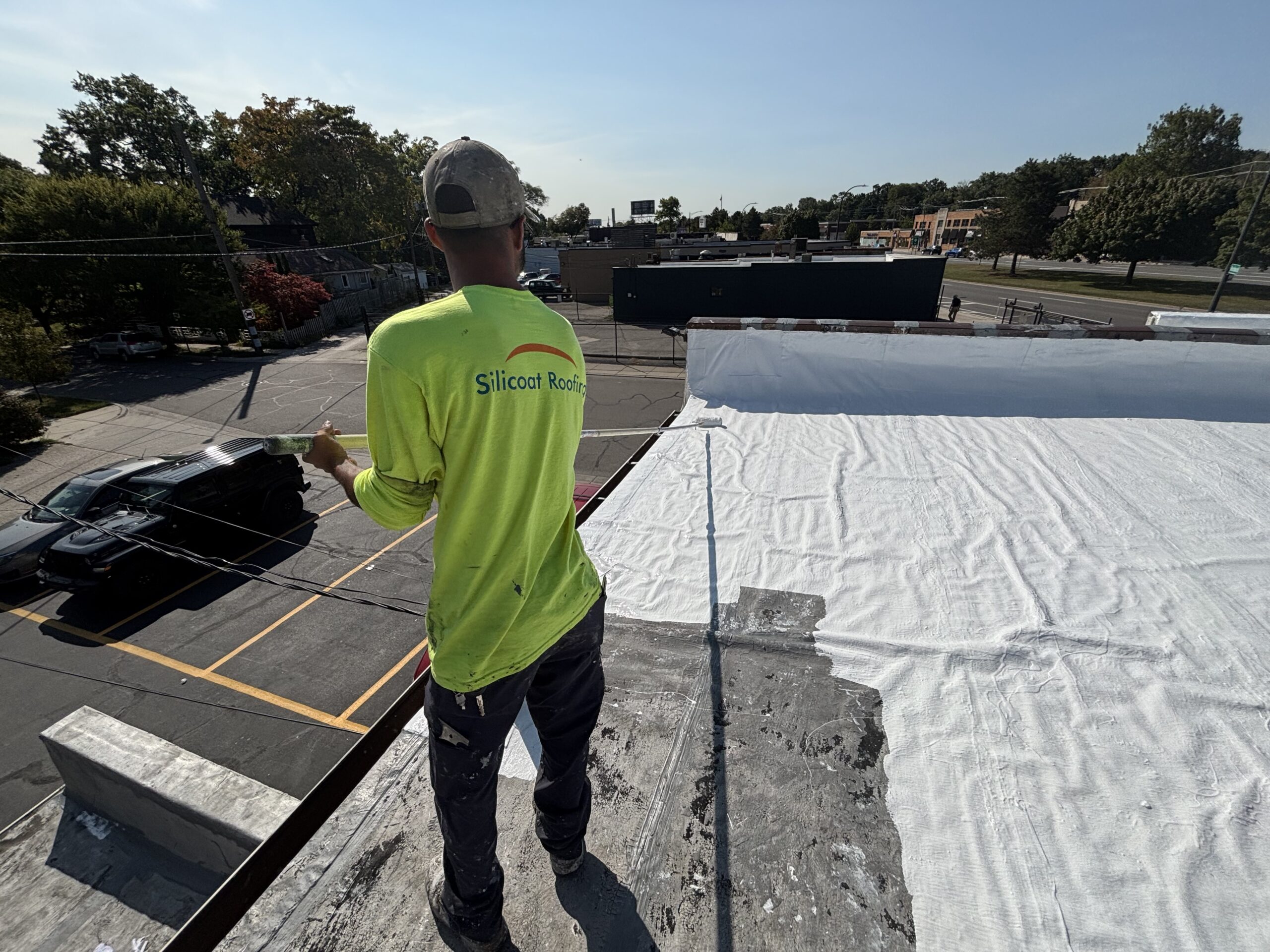 Silicoat Roofing technician performing roof maintenance during a commercial roof asset inspection