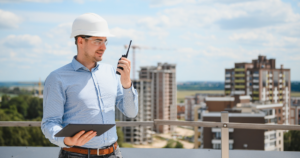 Facility manager checking commercial roof problems during a routine rooftop inspection
