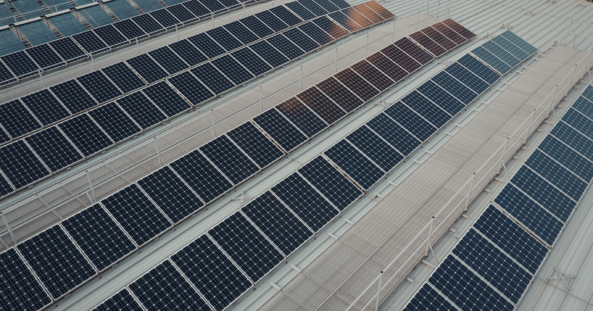 Roof coating for solar panels protecting a commercial flat roof under a solar array
