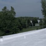 Completed white reflective flat roof coating by commercial roof coating contractor Silicoat Roofing Michigan