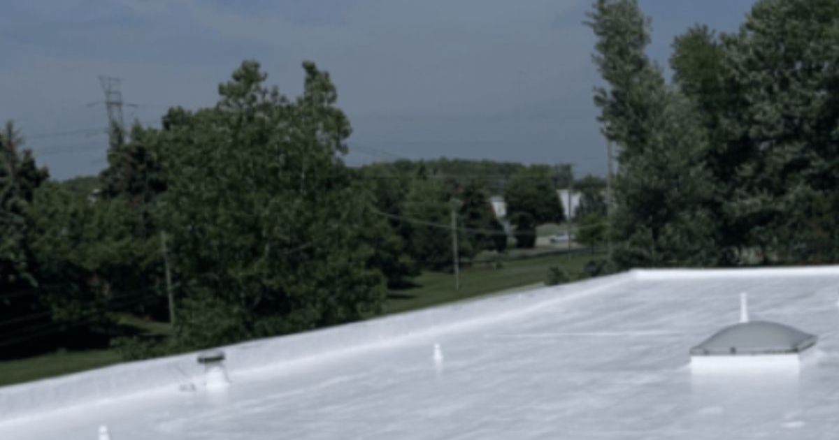 Completed white reflective flat roof coating by commercial roof coating contractor Silicoat Roofing Michigan