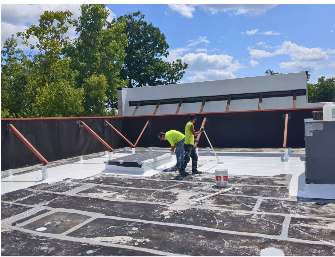 Silicoat Roofing technicians performing a commercial roof inspection on a flat roof